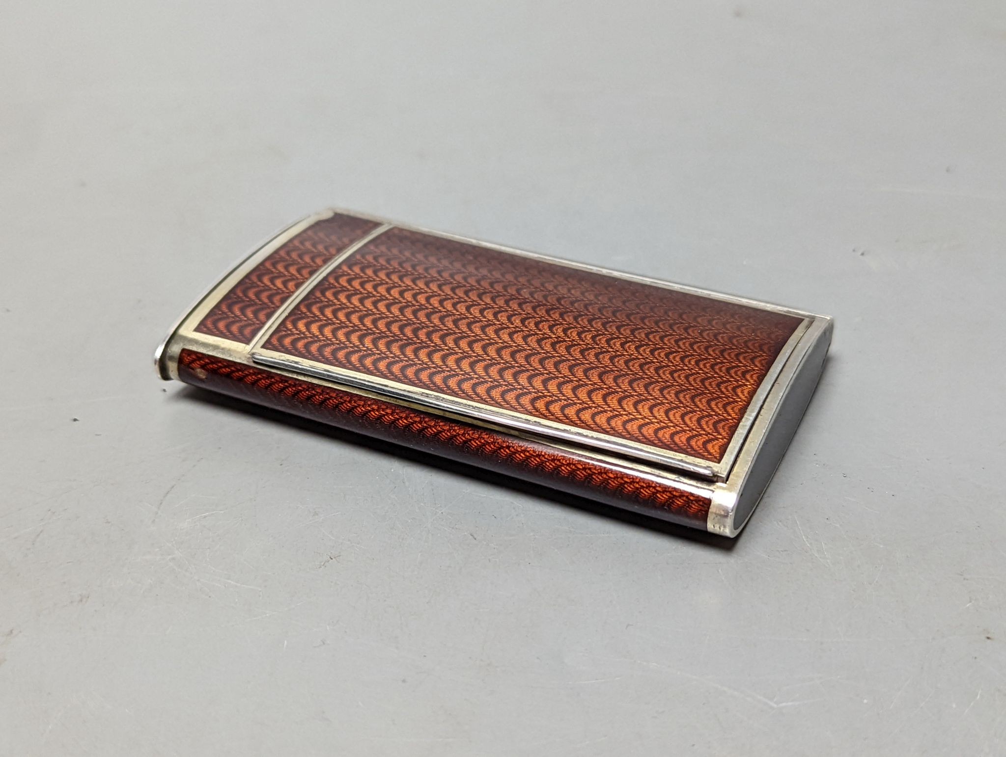 A 20th century Austro-Hungarian white metal and brown guilloche enamelled cigarette case, with match compartment?, 98mm (a.f.).
